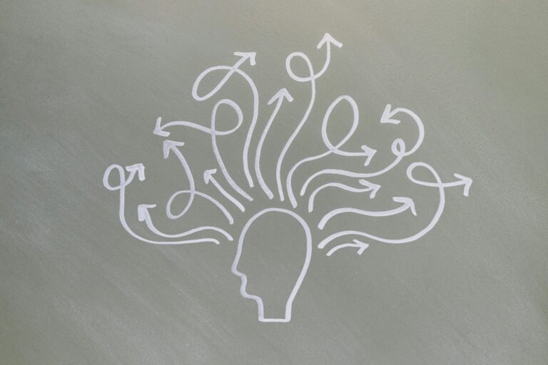 Conceptual chalk drawing illustrating mental health challenges with arrows representing thoughts.